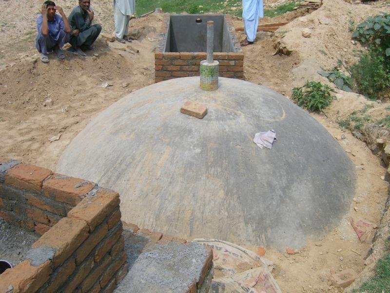 Fixed dome household biogas plant in Pakistan using cow dung.
